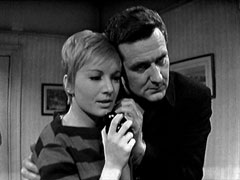 Steed holds Venus tight as he listens in on her telephone conversation