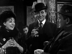 In the old-fashioned, wood-panelled pub, Steed, centre stage, shares a drink with Wescott on his left and Dicey on his right to celebrate Wescott’s acquittal
