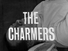title card: white all caps text reading ‘THE CHARMERS’ superimposed on a close-up of Vinkel lying dead on the floor in his fencing whites