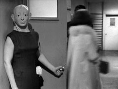Betty wears a bizarre mask to train the student to treat all women equally, regardless of beauty