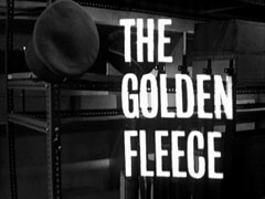 title card: white all caps text reading ‘THE GOLDEN FLEECE’ superimposed on two military caps hanging from hooks above an empty metal shelf