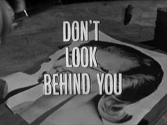 title card: white all caps text reading ‘DON’T LOOK BEHIND YOU’ superimposed on the cut-up photograph of Cathy