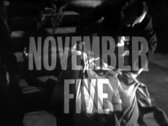 alternate title card: white all caps text reading ‘NOVEMBER FIVE’ superimposed on the fallen Dyson being covered by a blanket