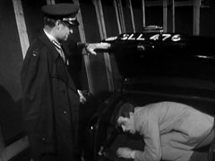 Major Zulficar opens his car boot to find Mark hiding inside