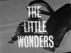title card: white all caps text reading ‘THE LITTLE WONDERS’ superimposed on a revolver and holster lying on a table