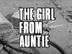 title card: white all caps text reading ‘THE GIRL FROM AUNTIE’ outlined in black and superimposed on the front wheel of the fallen bicycle, and the knitting that has fallen out of the basket