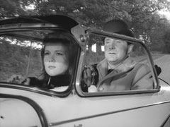 Emma drives while Steed is squeezed into the back of the tiny Messerschmidt car