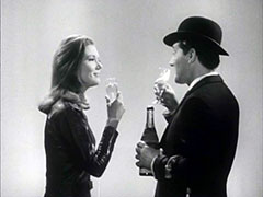 Emma and Steed toast each other with the champagne