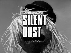 title card: white all caps text reading ‘SILENT DUST’ with faint outline superimposed on a close-up of the head of a scarecrow wearing a bowler hat