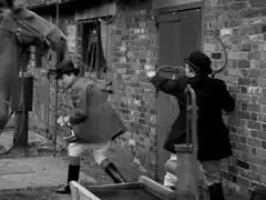 Steed ducks under a horse to evade the murderous lunge of Croft’s sickle