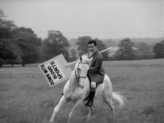 Steed displays superb horsemanship as he pivots his steed, brandishing a discarded placard as a weapon