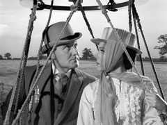 Steed and Emma depart in a hot air balloon; she wears Victorian-inspired clothing to match the conveyance