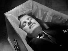 Marlow lies in his coffin