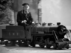 Sir Horace happily rides his miniature steam engine