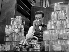 Steed peers into the last jar of honey after emptying them all while searching Reed’s flat