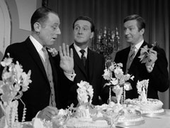 Lovejoy, Steed and Dinsford taste the wedding cake as Lovejoy expands on the plot to kill Steed’s cousin