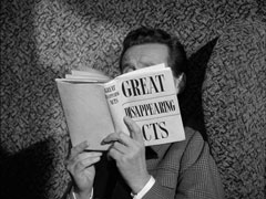 On the train, Steed avoids speaking to Smallwood by burying himself in his book, titled ‘GREAT DISAPPEARING ACTS’
