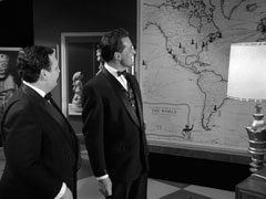 Steed remarks that Chessman’s business is booming as they regard the huge world map on the wall