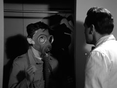 Steed, in his white waiter’s uniform, encounters the gas-mask wearing guard hiding in the wardrobe or room 621