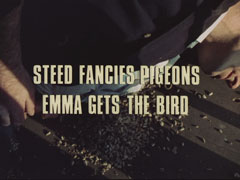 subtitle card: white all caps text with black dropshadow to the left reading ‘STEED FANCIES PIGEONS -
			EMMA GETS THE BIRD’ superimposed on Danvers lying on the floor of a fire-tower with bird seed spilling out of his jacket