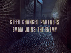 subtitle card: white all caps text with black dropshadow to the left and gold dropshadow to the right reading ‘STEED CHANGES PARTNERS -
			EMMA JOINS THE ENEMY’ superimposed on Percy and Algy walking away down the cobble-stoned alley