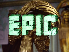 title card: white all caps text made to look like stone blocks, with perspective from top right, reading ‘EPIC’ superimposed on a close-up of the top of a film award statuette in the shape of a woman holding a cloth above her head