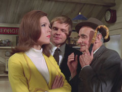 Crewe chuckles at the recording on the umbrella and declares it isn’t a train at all; Mrs. Peel looks confused, possibly because of her bright yellow suit