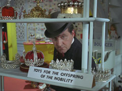 Steed inspects a shelf in Martin’s toy store which holds the ‘TOYS FOR THE OFFSPRING OF NOBILITY’