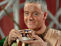The Master has a cup of tea, his fake tan revealed now he’s removed his turban