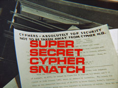 title card: red all caps text reading ‘SUPER SECRET CYPHER SNATCH’ superimposed on a typewritten page headed CYPHERS - ABSOLUTELY TOP SECURITY NOT TO BE TAKEN AWAY FROM CYPHER H.Q.