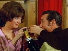 Tara and Steed celebrate another case closed with a bottle of champagne