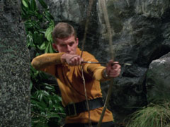Huxton aims his rudimentary bow and arrow at Tara
