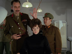 Tara is interrogated by Mannering and Soo; Toy and Ling Ho stand guard in the background