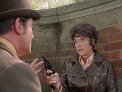 Tara is backed up against the bridge and, no longer knowing who to trust, points her revolver at Steed