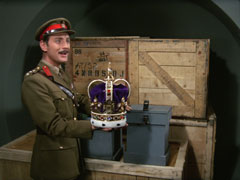 Colonel Corf happily shows Steed forgeries of the Crown Jewels, stored in crates in his warehouse