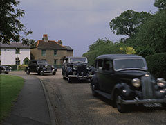 A trail of black cars blatantly follow Tara and Steed