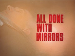 title card: red all caps text reading ‘ALL DONE WITH MIRRORS’ superimposed on an orange screen in which we can barely see Arkin lying dead because of the sunlight flaring off his mirror