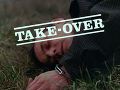 title card: white all caps text in serif font, bordered top and bottom and askew counter-clockwise, reading ‘TAKE-OVER’ superimposed on a close-up of the dead man lying in a field