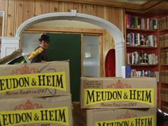 Steed returns home to find his flat filled with crates of Meudon & Heim champagne