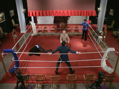 Steed fights Dangerfield and Zaroff in the boxing ring of the Baronet Sporting Club