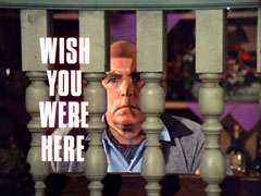 title card: white all caps text reading ‘WISH YOU WERE HERE’ superimposed on Uncle Charles peering through the rails of the bar room, evoking a jail cell