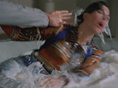 Tara is soscked to the skin and milk pours off her face as she fights Sloman in the vat of milk