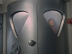 The steel butter machine, with Tara trapped inside, pressed against one of the wedge-shaped windows